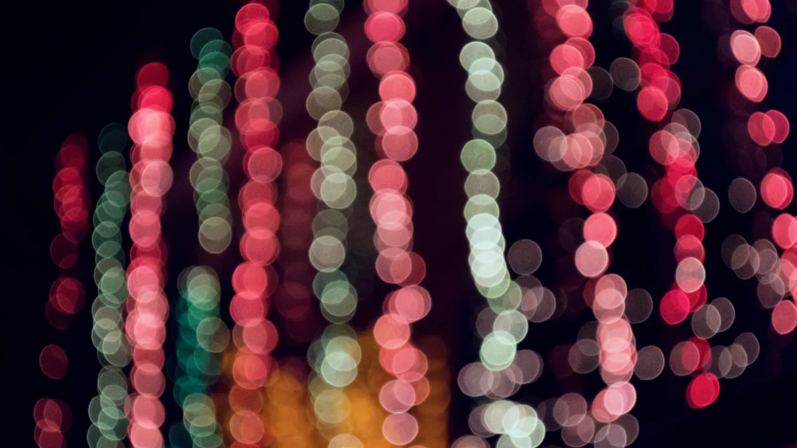 Soft red and green lights against a dark background