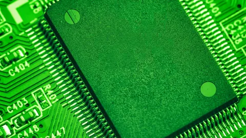 Close-up of a green circuit board with a processor chip