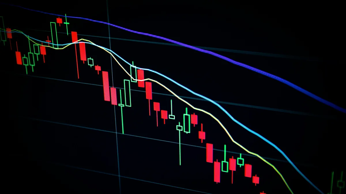 Candlestick chart of market prices on a dark screen