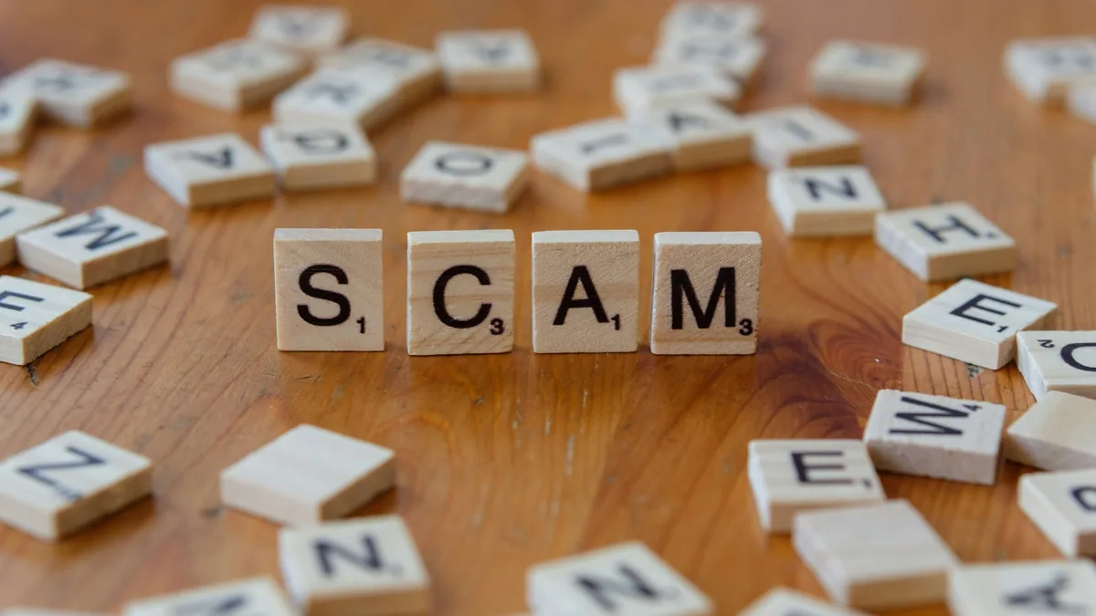 The word scam spelled with letter tiles on a wooden table