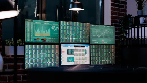 Dark trading room with wall screens showing price charts
