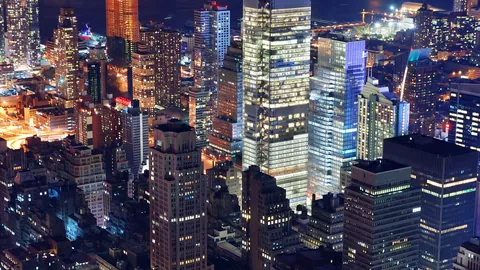 City skyline of office towers lit up at night