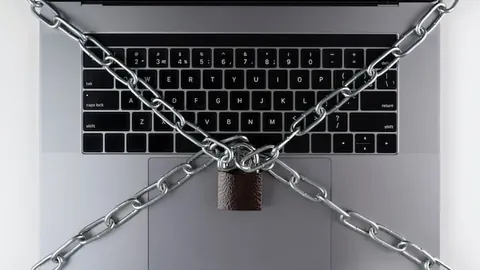Flat lay laptop with lock and chain
