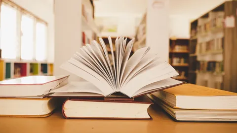 Open book standing on a table in a library