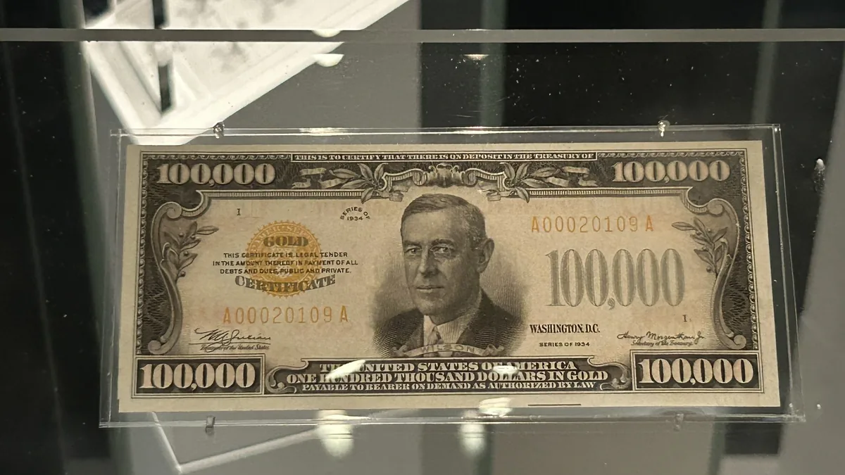 A 1934 United States gold certificate on display in a museum case