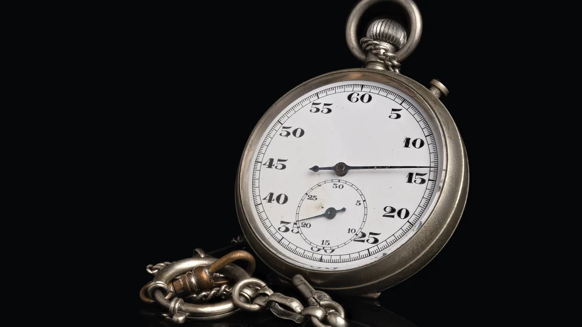 A vintage mechanical stopwatch on a black background