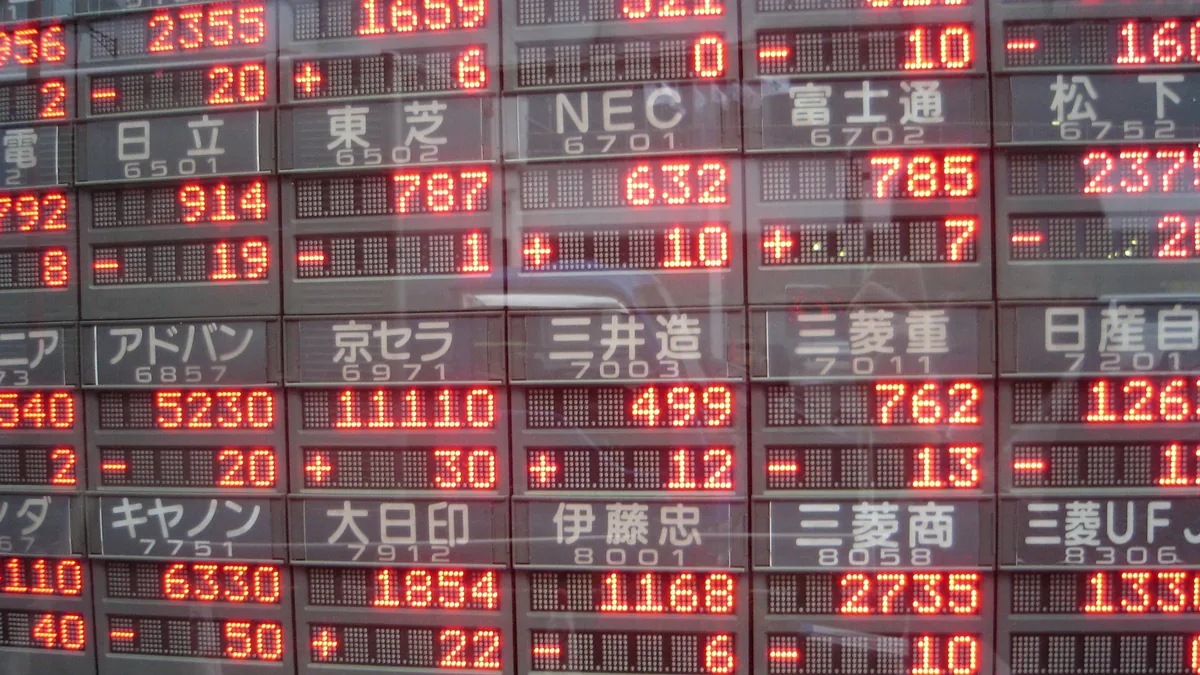 Red and green prices on an electronic stock board in Tokyo