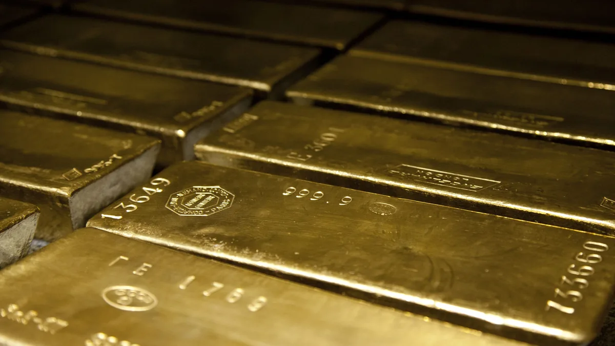 Four 400-ounce gold bars of 999.9 fineness lying side by side