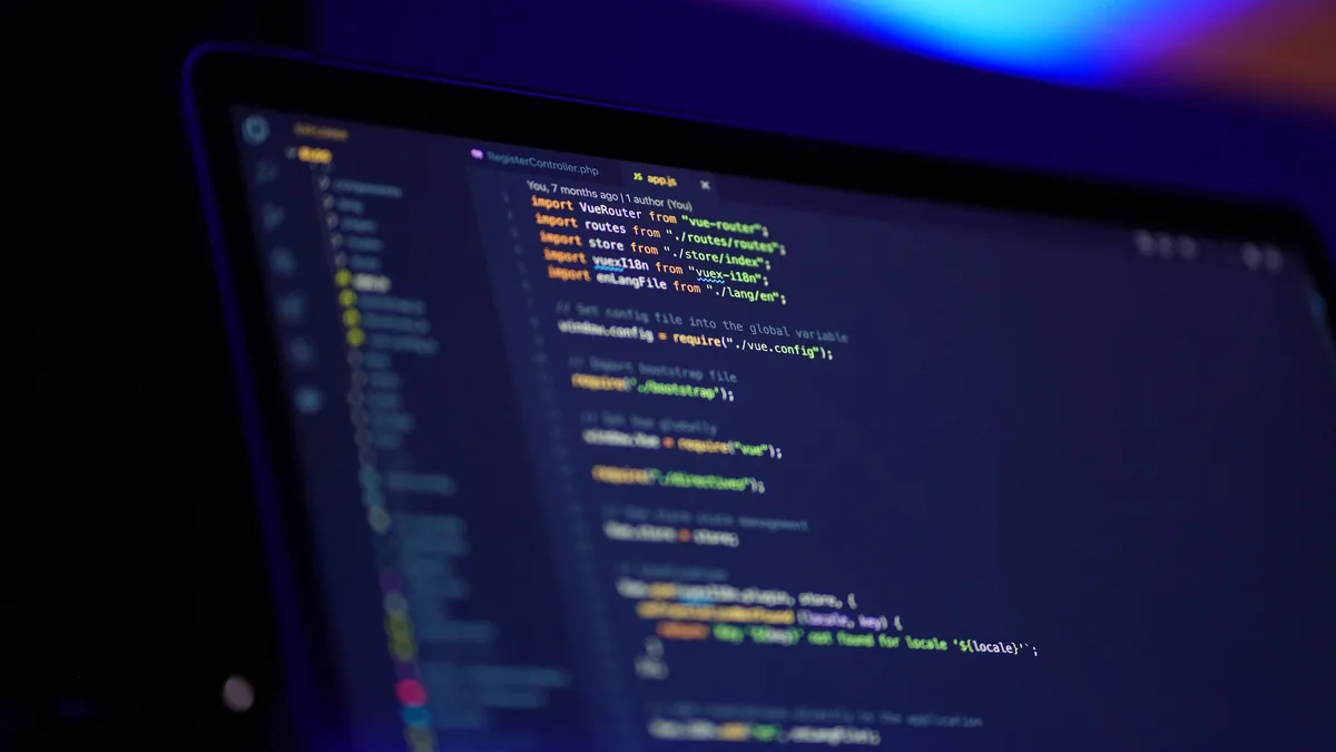 Laptop screen displaying colourful programming code