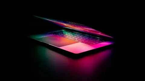 Laptop with a glowing keyboard in a dark room