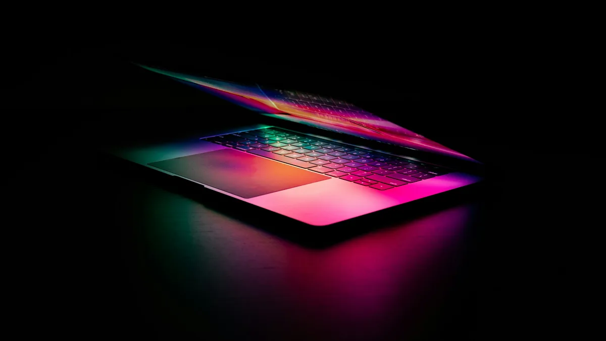 Laptop with a glowing keyboard in a dark room