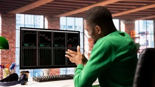 Focused Man Analyzing Stock Market Data On Screen