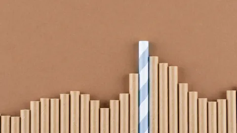 Bar chart made of wooden pegs with one bar standing taller