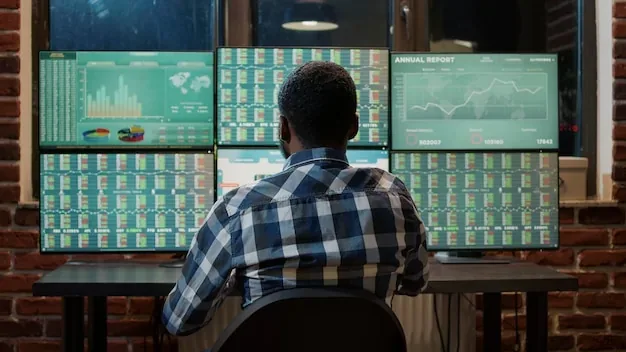 Forex trader analyzing market charts to plan commodities exchange on multi monitor workstation. Financial investment with banking profit statistics and real time stocks changing