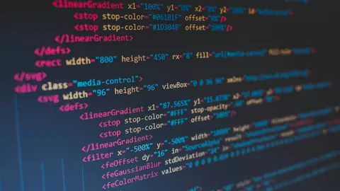 Lines of colourful source code on a dark screen