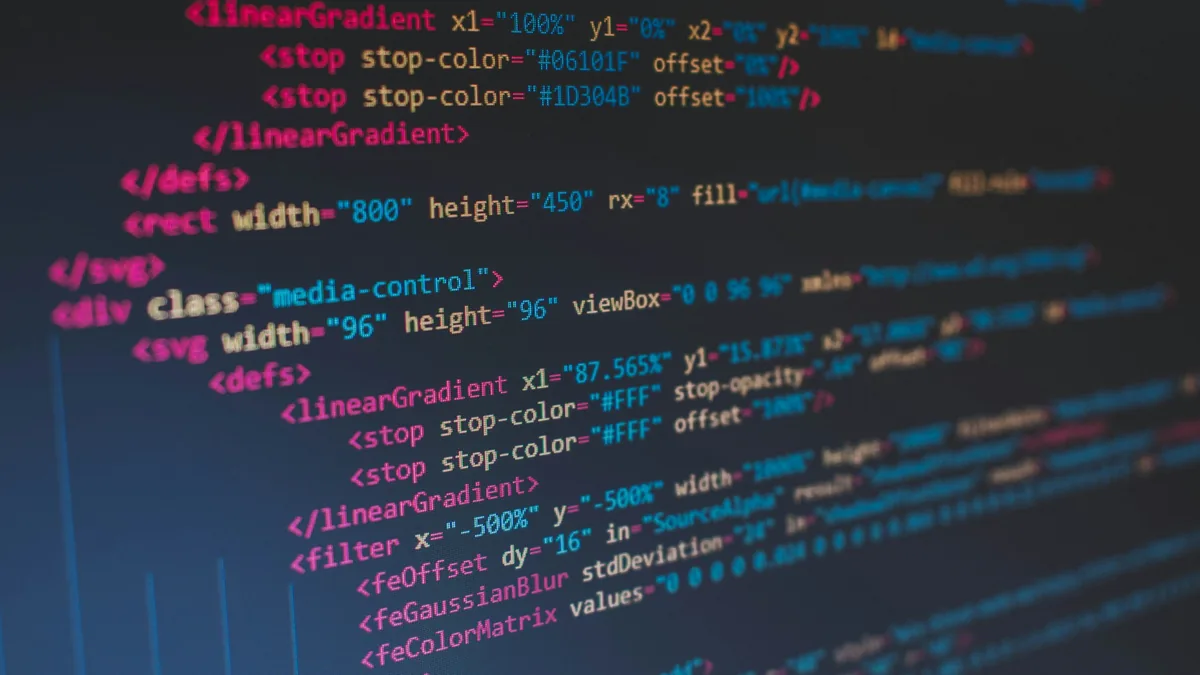 Lines of colourful source code on a dark screen