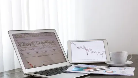 Laptop and tablet with business reports
