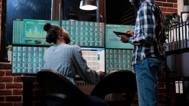 Financial analysts near multi monitor workstation using tablet device to analyze capital profit risks. Hedge fund company professional agents in office, reviewing trading strategies to take profits