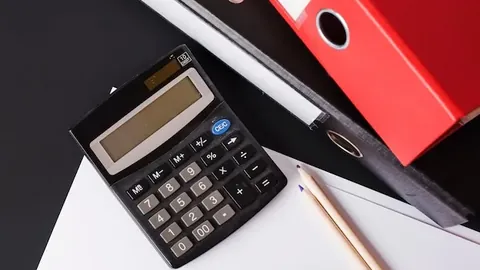Calculator; pencils; paper and paper files on black background