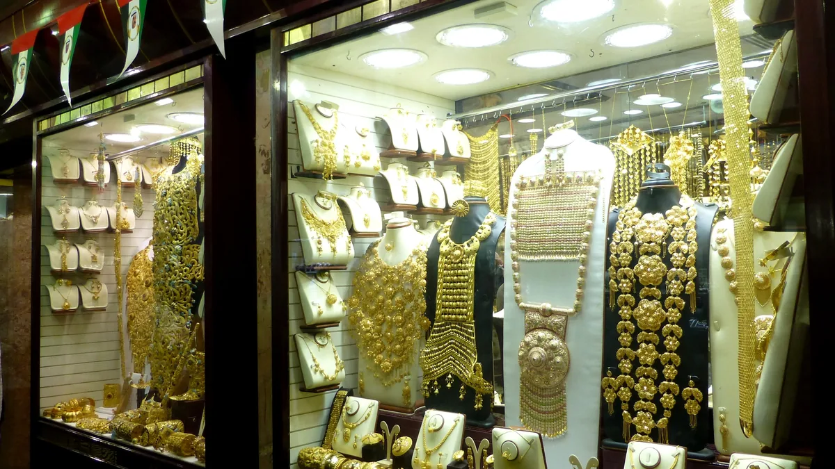 A jewellery shop window full of gold necklaces in the Dubai Gold Souk